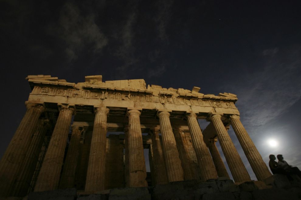 FILE - The moon shines on the ancient Parthenon temple on Acropolis hill in Athens on Wednesday, Aug. 9, 2006. Through the millennia, humans have asked: How did everything come into existence? Modern science's answer is the Big Bang Theory, which posits that the universe sprang in an instant from a sub-atomic fragment. The ancients, however, did not have $900 million machines to plumb the secrets of the universe. In the 4th century BC, the Greek philosopher Aristotle posited the world always existed, at the center of the universe. (AP Photo/Petros Giannakouris)